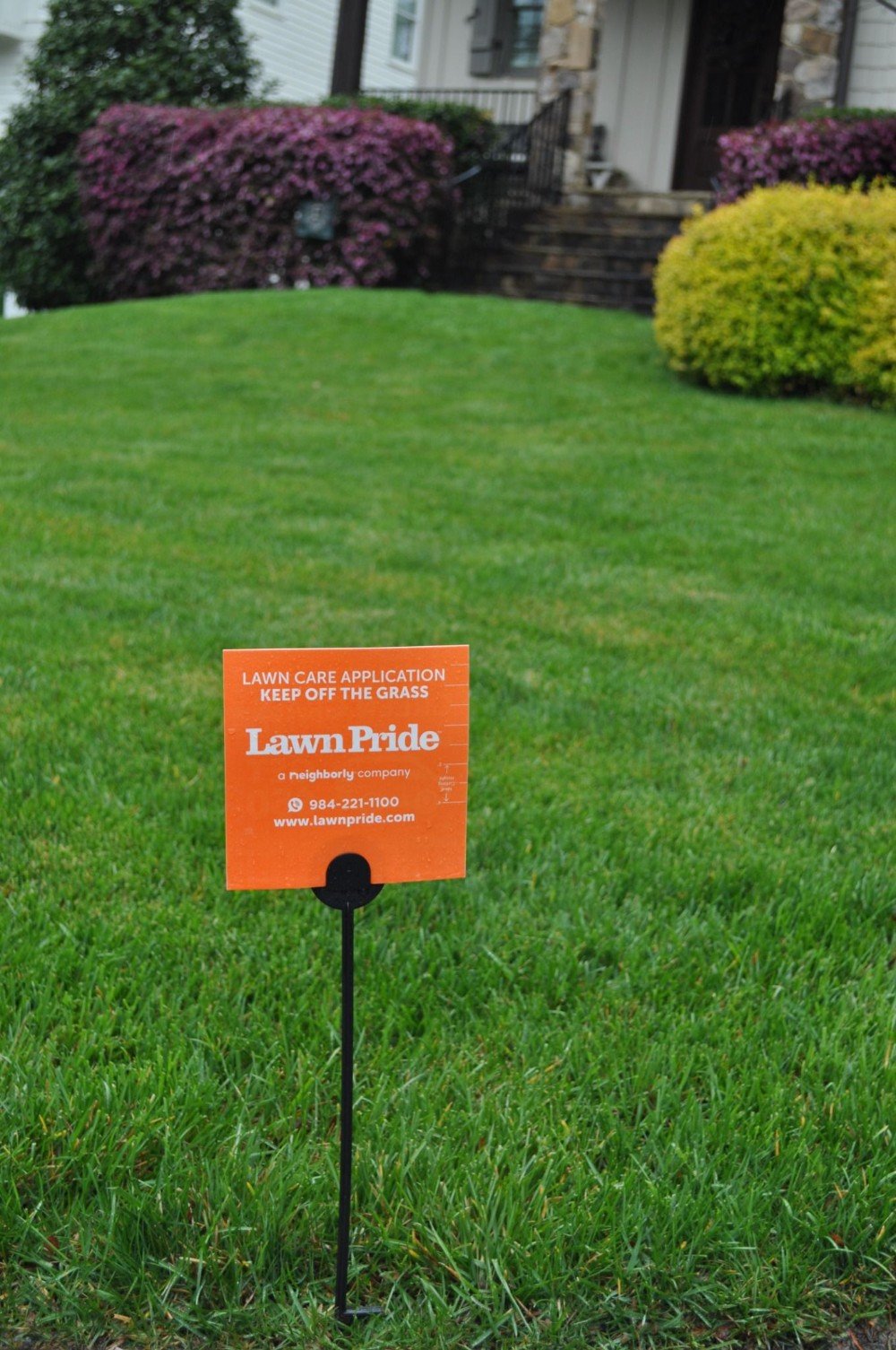 Orange Lawn Pride after service sign in fescue lawn