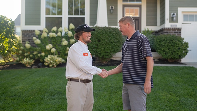 Lawn Pride pro shaking hands with customer