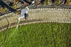 Liquid aeration being applied to a lawn using a spray applicator.