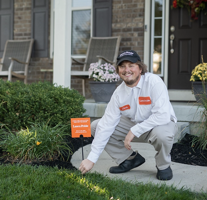 Lawn Pride professional putting sign on the grass.