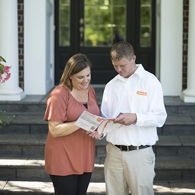 Lawn Pride professional working with the customer
