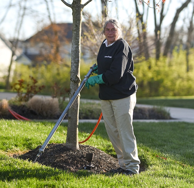 Lawn care worker doing edge trimming.
