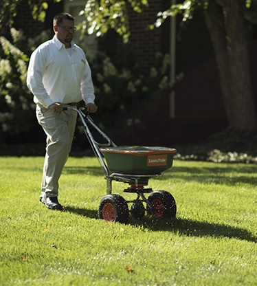 Lawn Pride specialist cutting the grass
