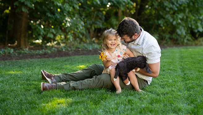 Father and daughter on the lawn.