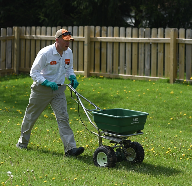 Lawn Pride professional fertilizing the lawn