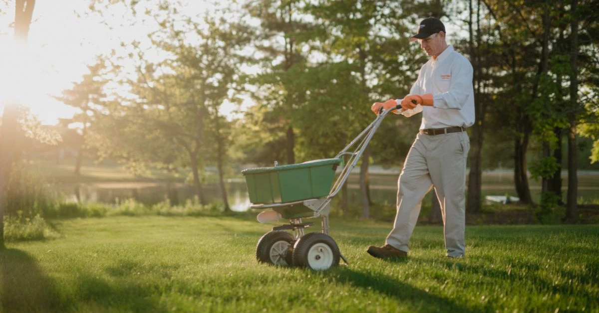 LawnPride professional fertilizing the grass