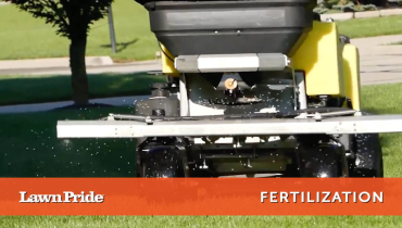 Applying fertilizer to a lush green lawn.